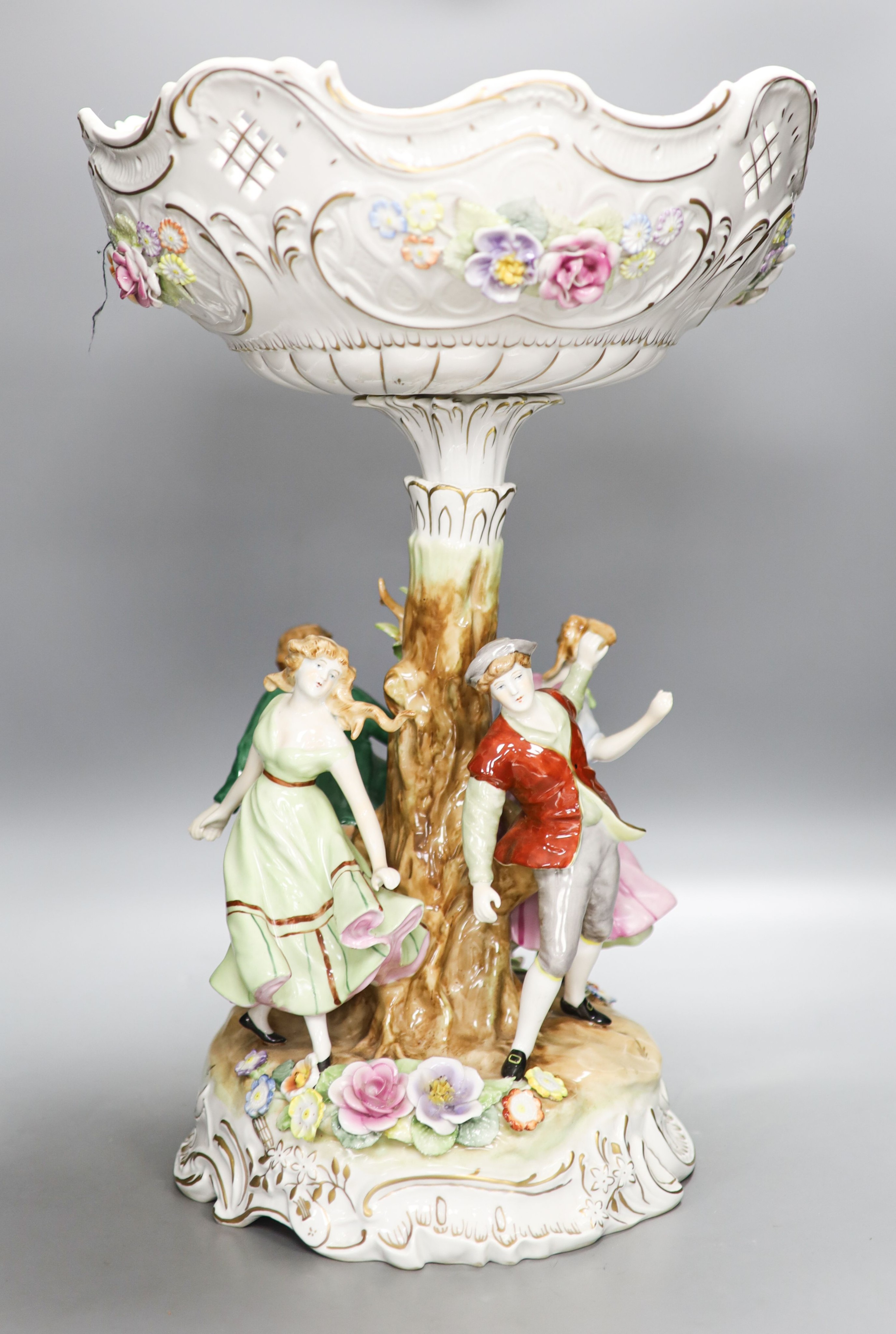 A German porcelain fruit stand, the stem decorated with four dancing figures 51cm